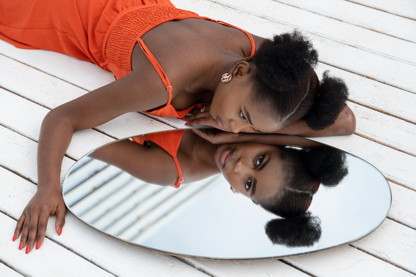 young-woman-with-red-dress-posing-outside-mirror.jpg